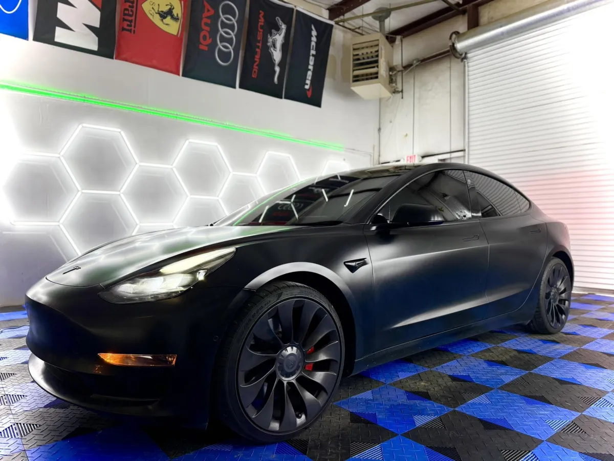 Dark Tesla Model 3 with window tint at Venom Tint Acworth