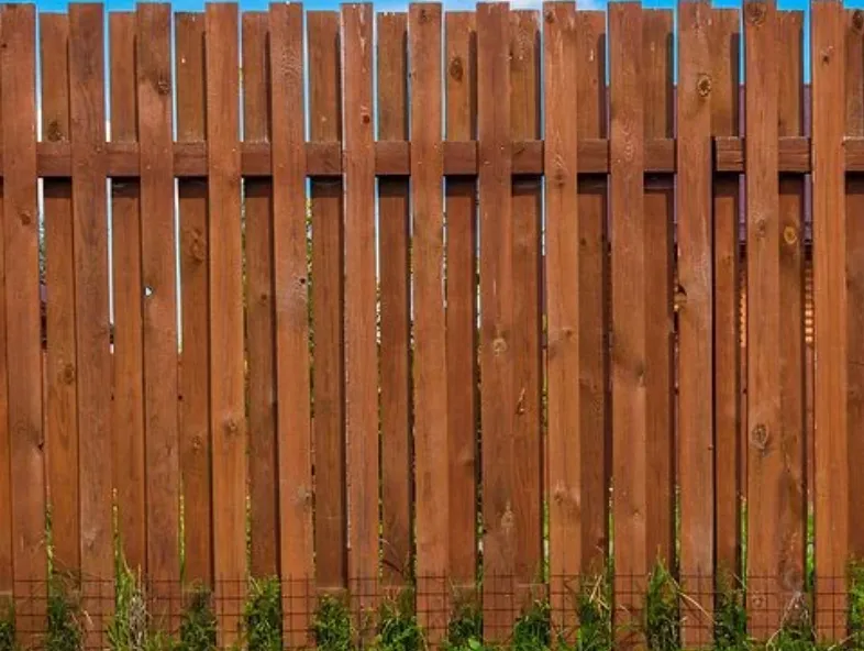 Clean architectural shadow lines of bright white virgin vinyl tongue and groove fence