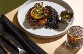 people sitting at tables under a tent
