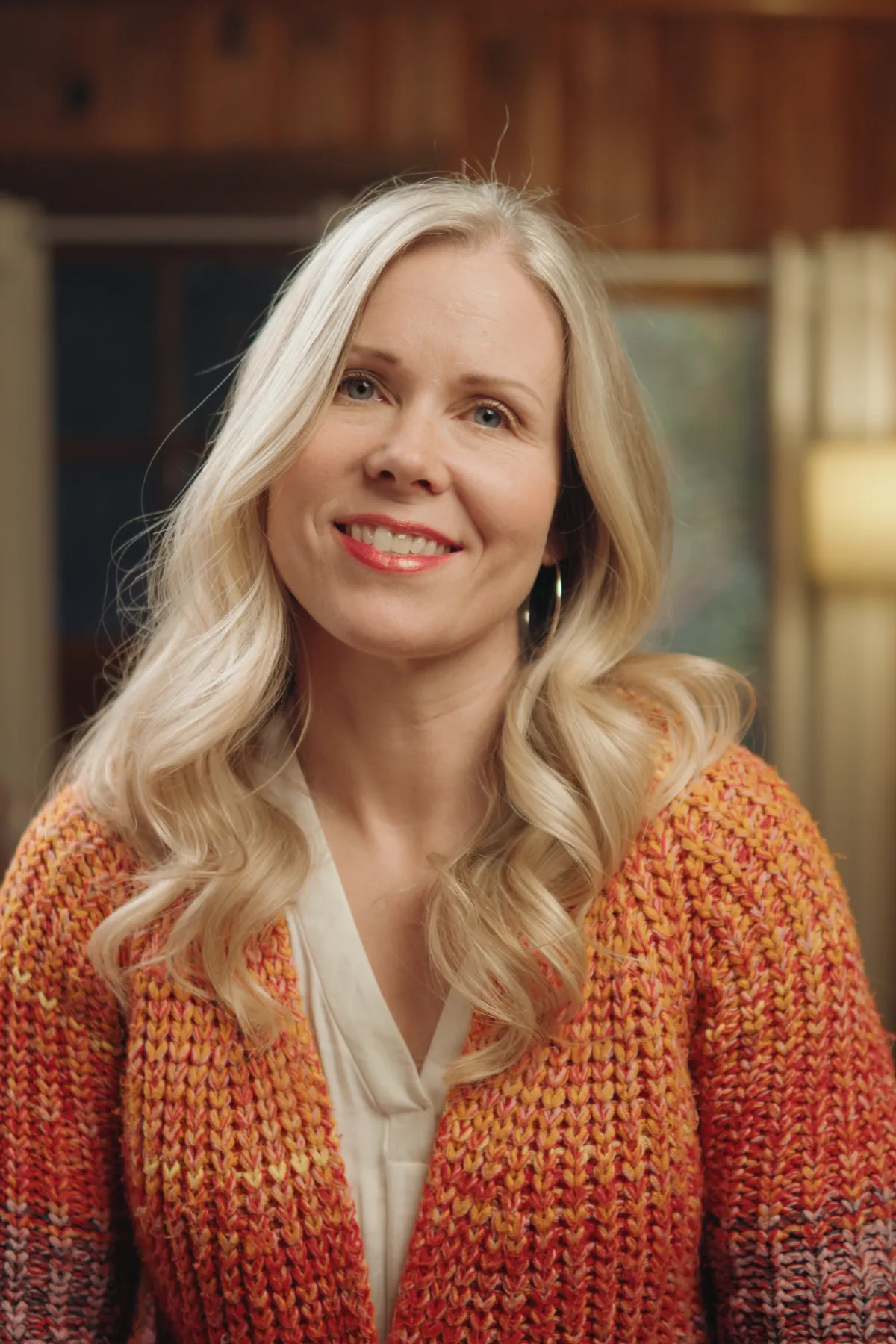 Instructor smiling with watercolor palette and sketchbook