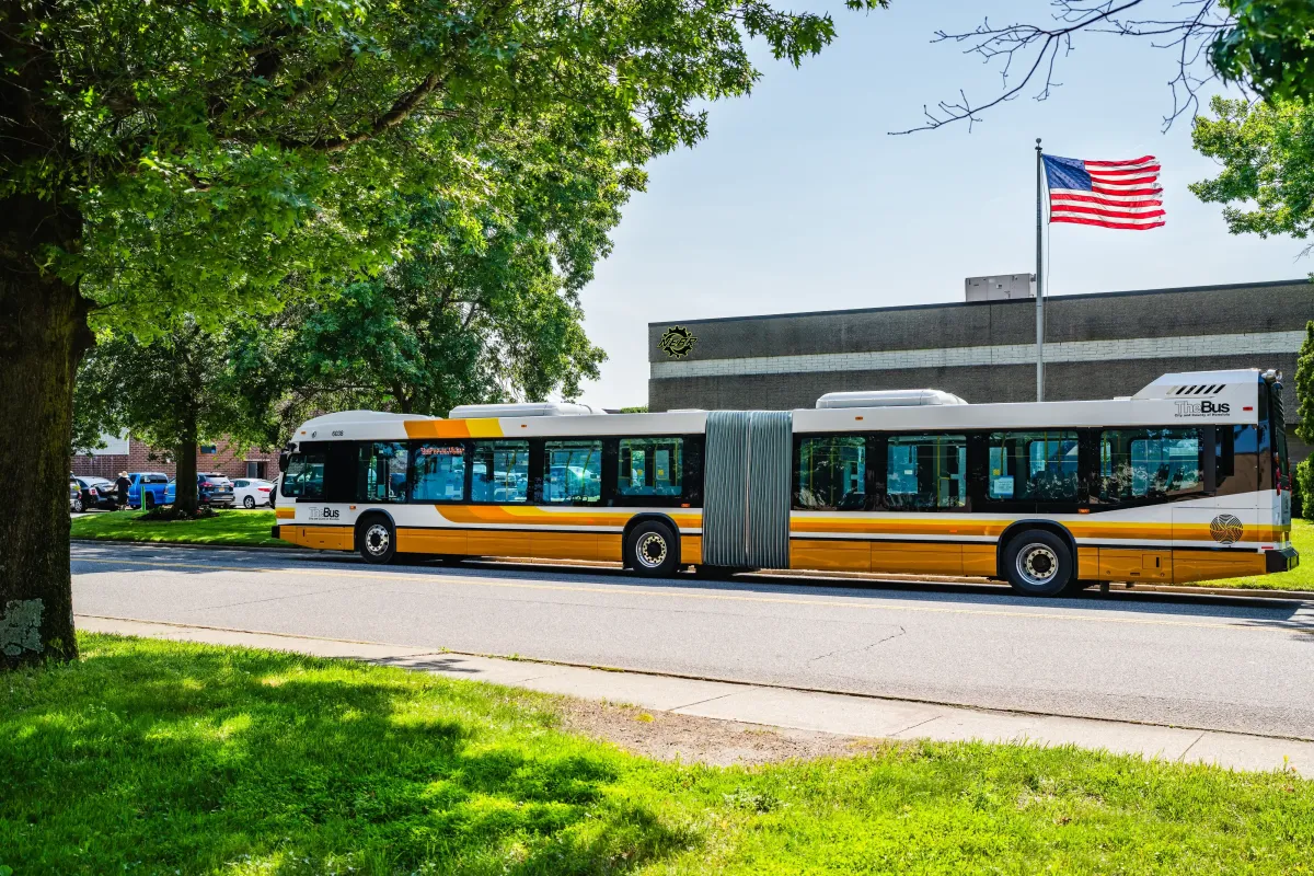 New transit bus parked outside NEBR facility during pre-delivery inspection