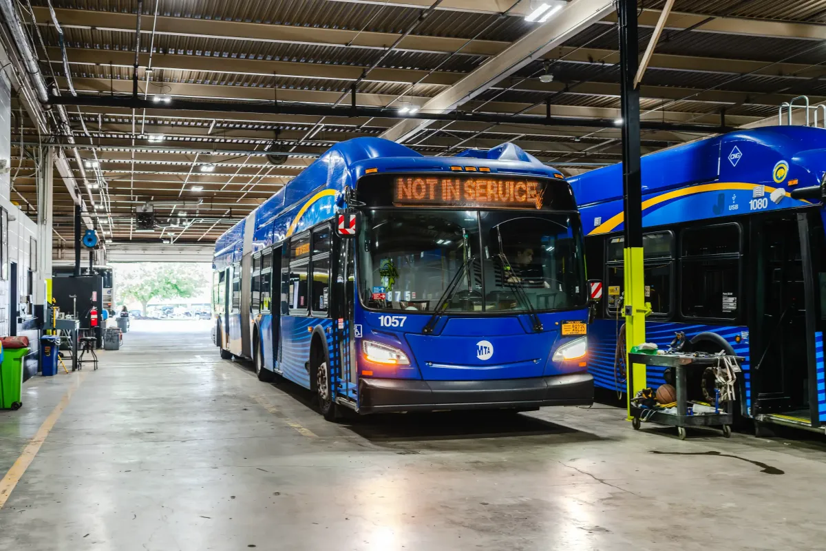 Hybrid electric buses parked inside NEBR maintenance shop