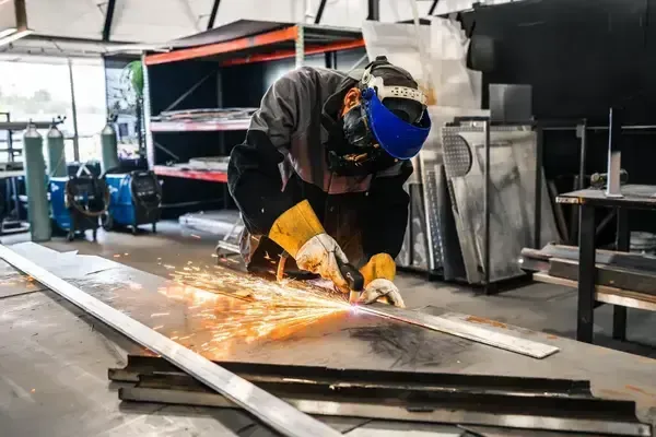 Welder fabricating metal components inside NEBR facility