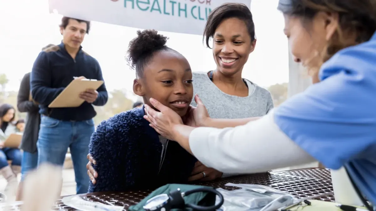 Healthcare professional speaking with a patient in a supportive setting, illustrating minority health and equity: closing the care gap today through compassionate, patient-centered care and improved access to health services.