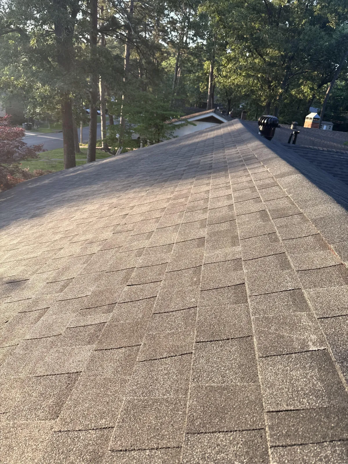 The image captures shingles installed correctly on a roof while the sun hits it.