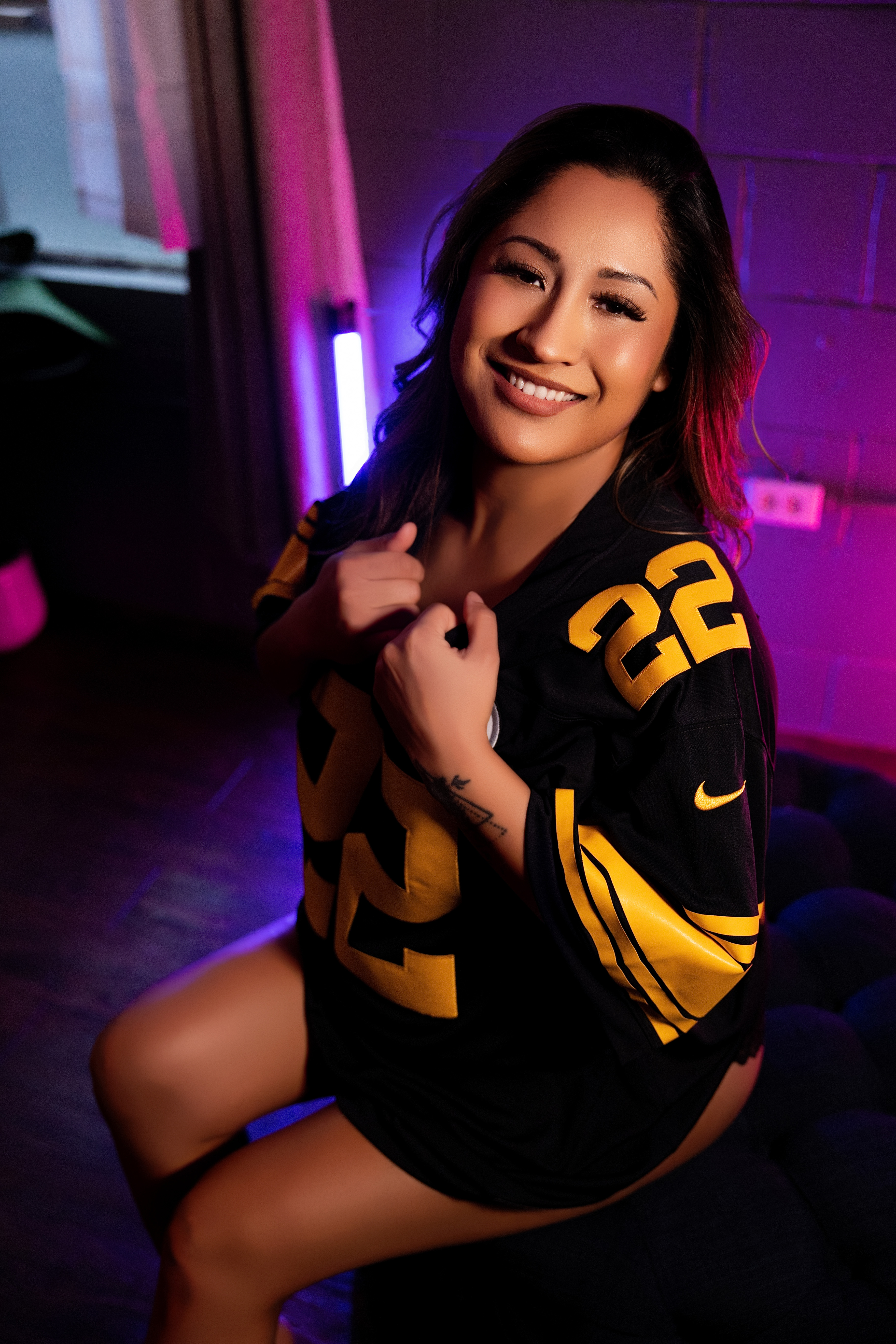 Woman in an oversized sports jersey, playful Spokane boudoir photography