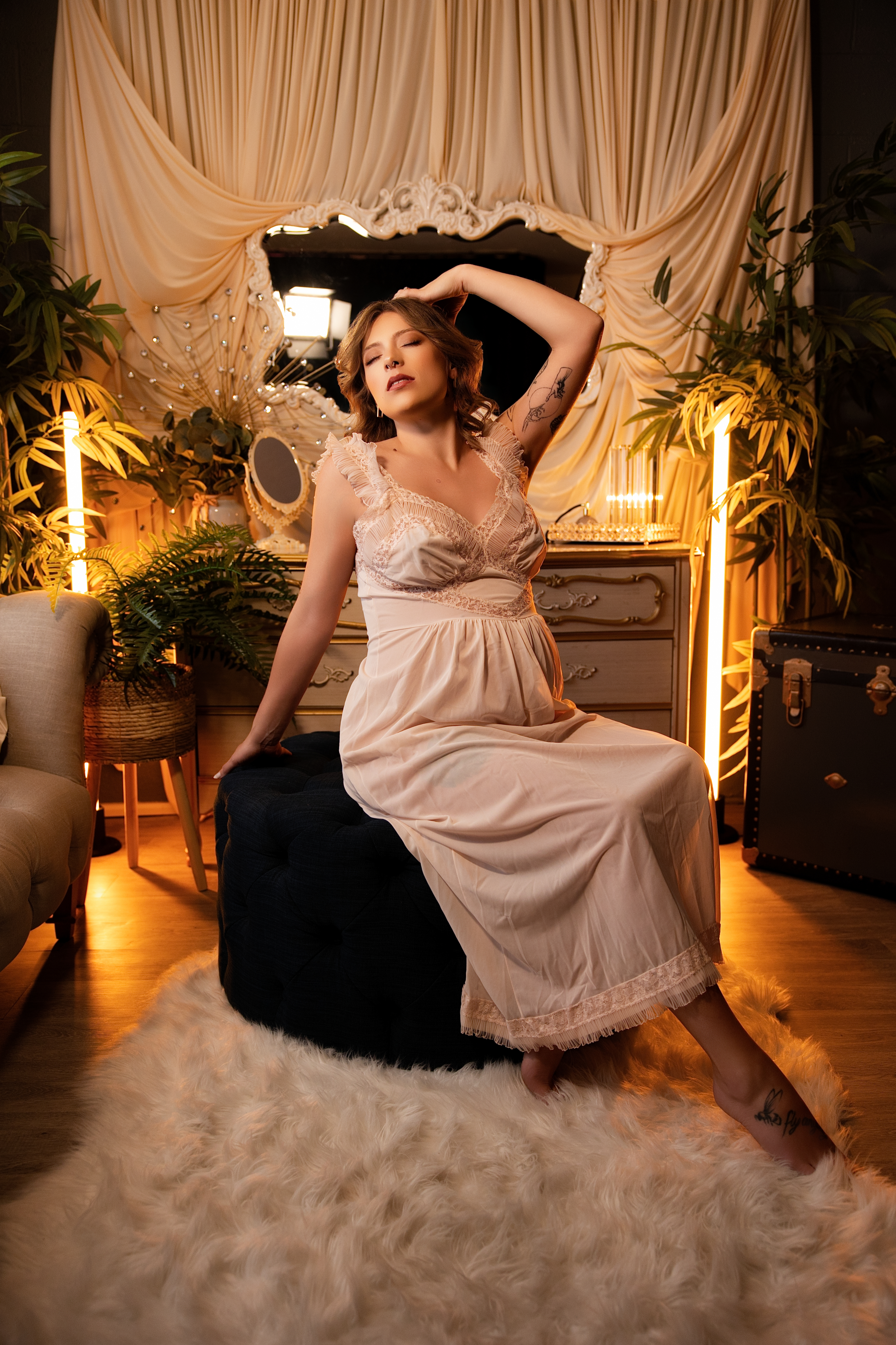 Woman in a silk robe at a lit vintage vanity, Spokane boudoir photography