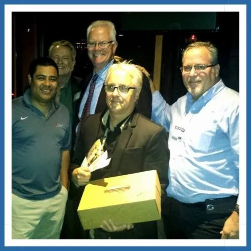 Masters In Networking group members at a raffle event, holding tickets and a drop box