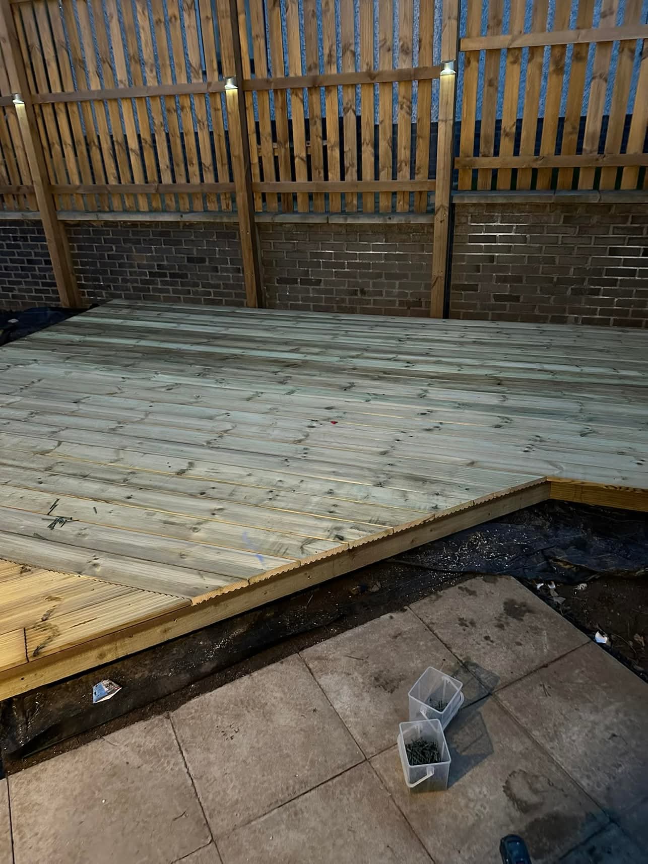 Timber garden decking with fence lighting installed by Equip2Save