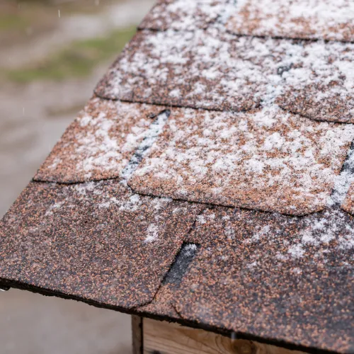 Visible hail damage on siding, gutters, and windows after a severe storm