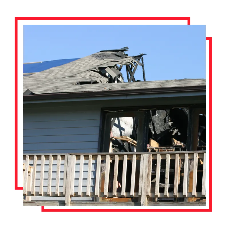Homeowner reviewing fire and flood damage insurance claim details after serious property loss