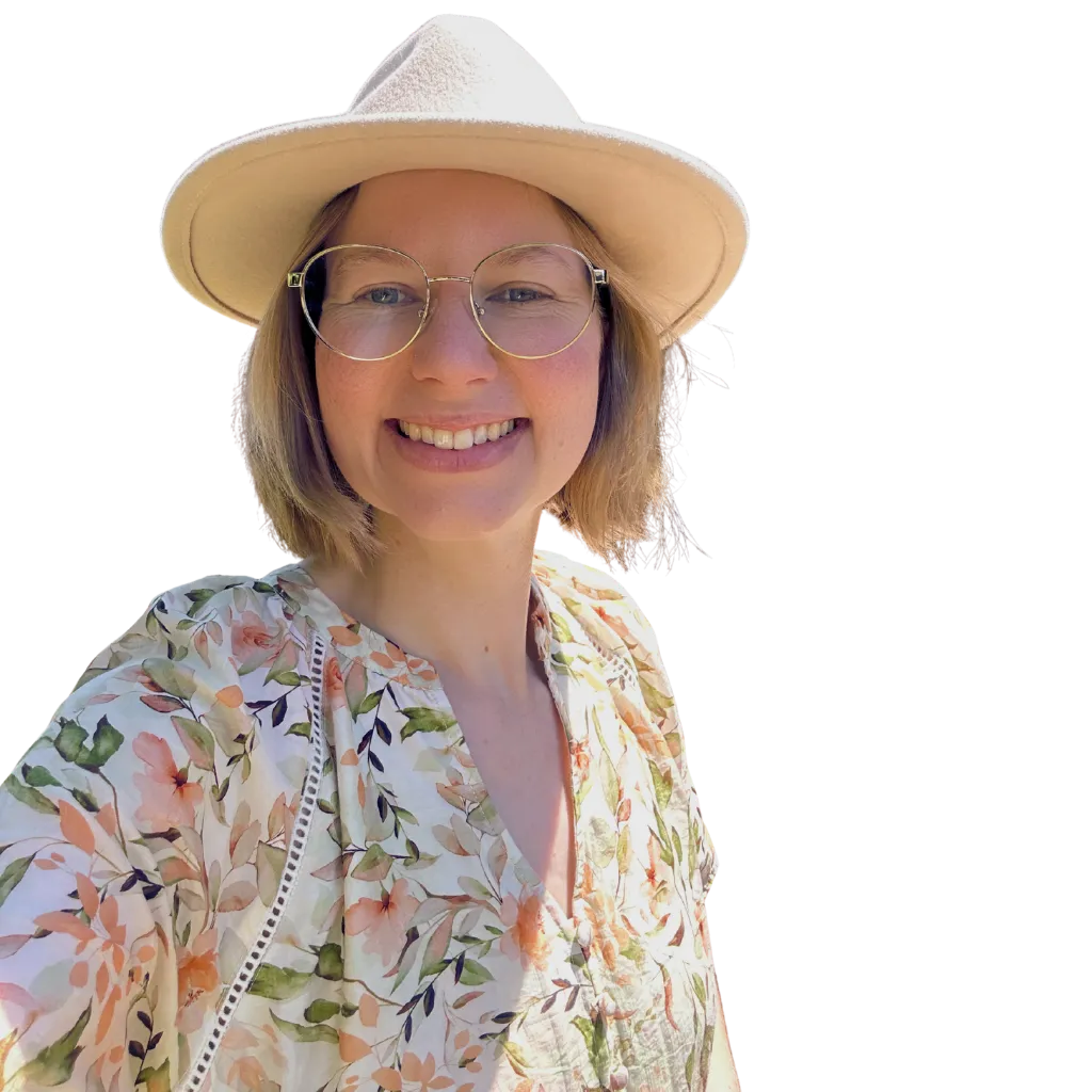 Course facilitator smiling softly, seated in a calm, light-filled space