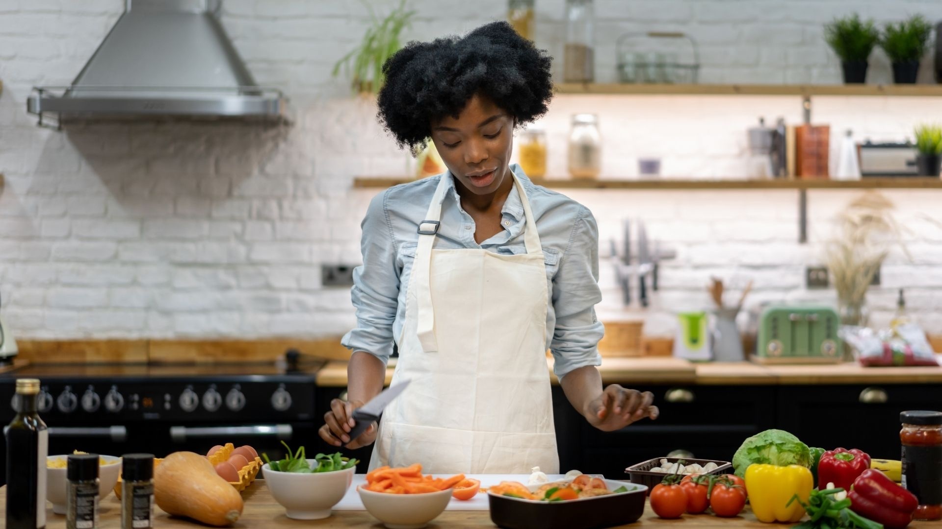 Woman cooking and providing meal services for postpartum moms with Elephant Baby, the leading postapartum care agency in Missouri and Illinoi
