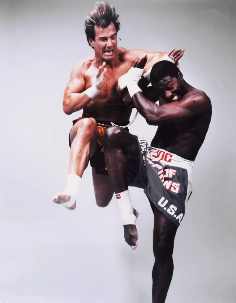 person holding black red yellow and green round analog clock