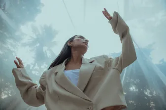 woman in black dress shirt using MacBook