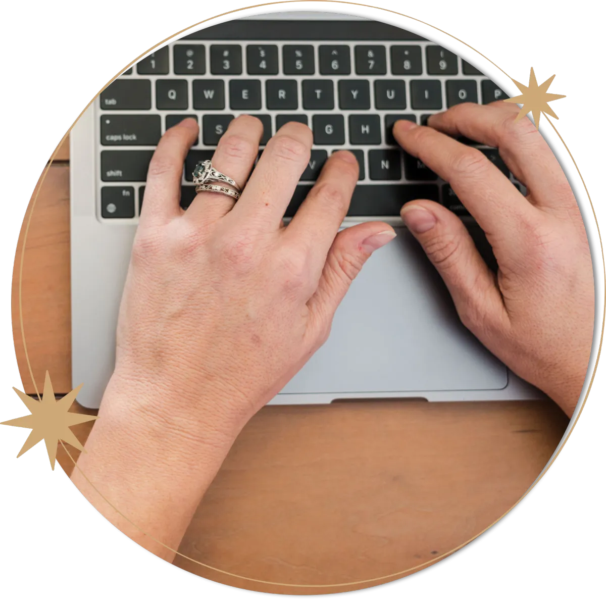 Photo of Bryn Brown, spiritual business coach for healers and coaches using Human Design, typing on a laptop keyboard