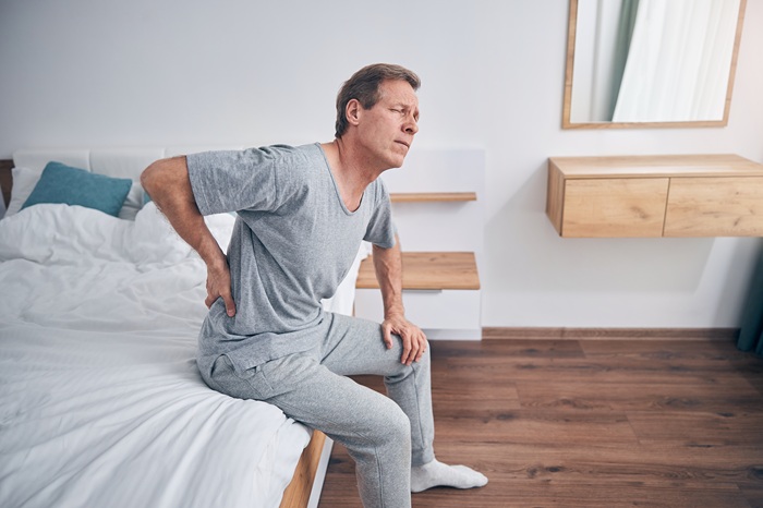 Man waking up with Sciatica pain