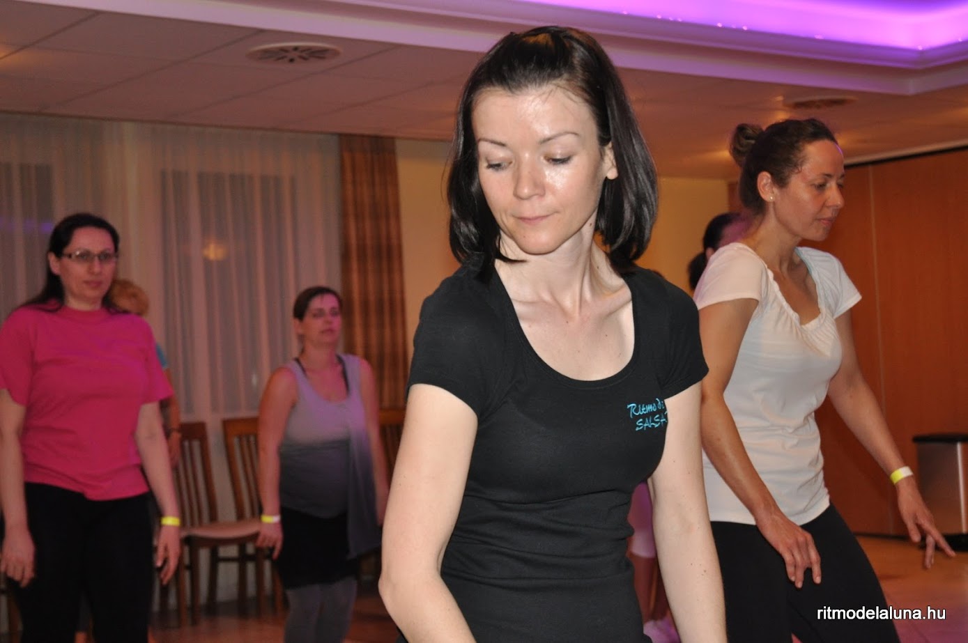 a full moon seen through the branches of a tree