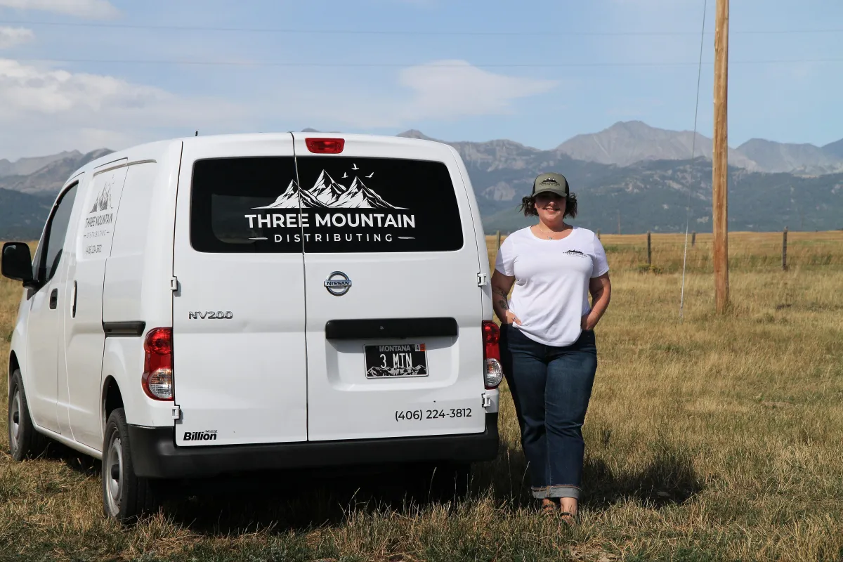 Caitlin standing by her delivery van in Livingston, M