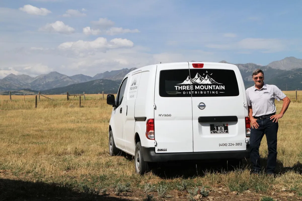 Jim standing by her delivery van in Livingston, MT