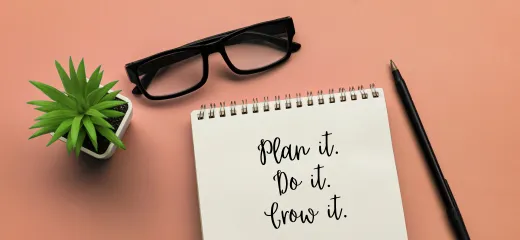 Notepad with the words 'I have a plan' and a speaker next to it