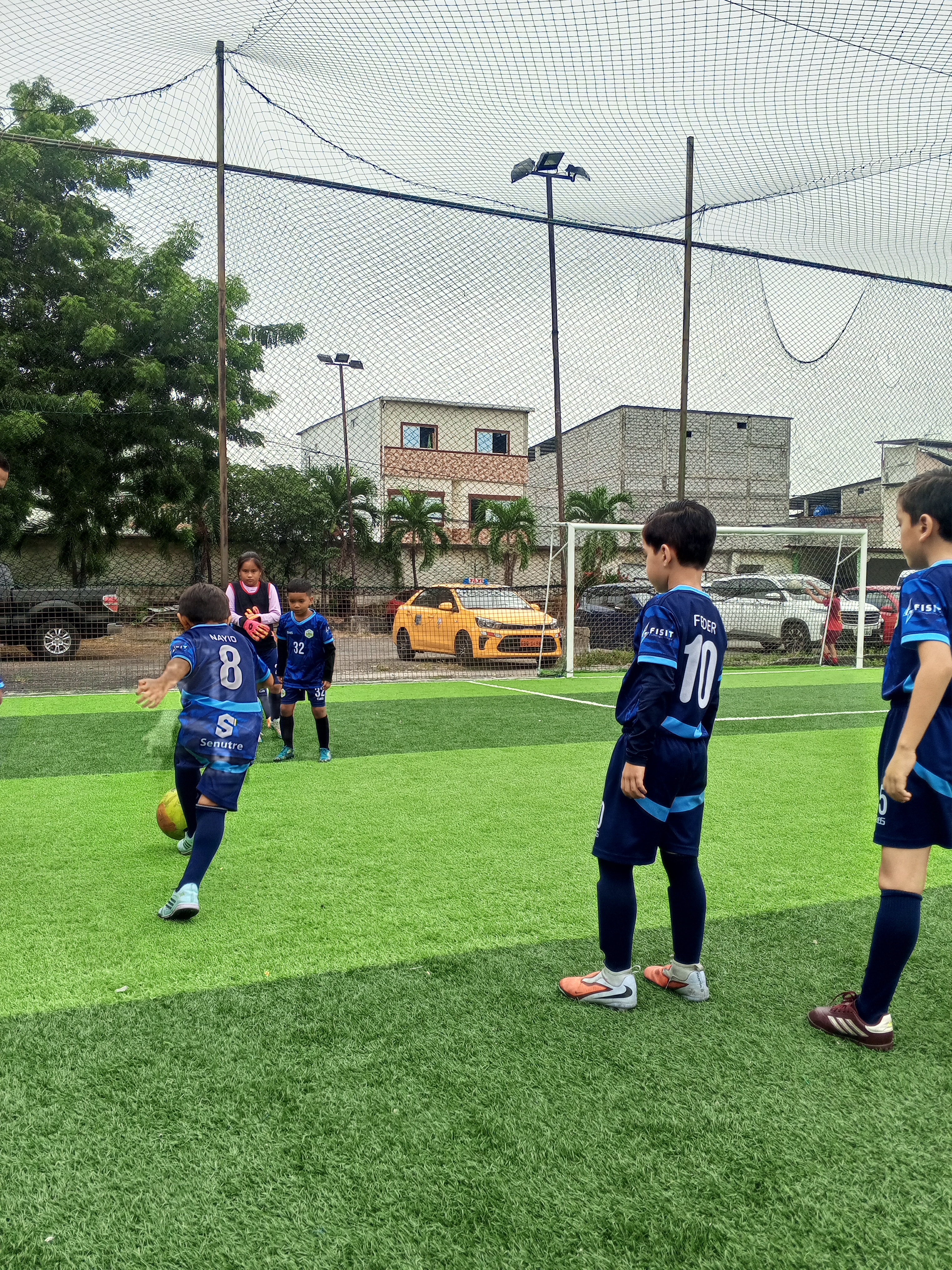a soccer ball being held by a person on a field