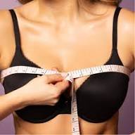 Woman in black bra grasping measuring tap