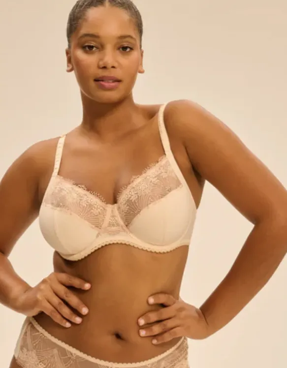 Woman in red bra with a professional bra fitter holding measuring tape