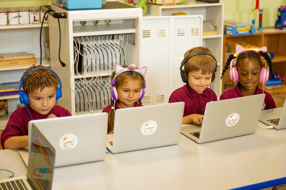 Children learning on laptops