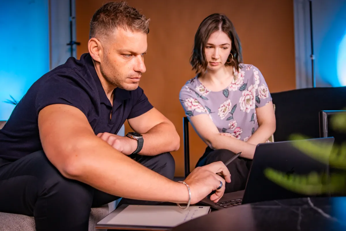 Adam and a client working through a build at the laptop