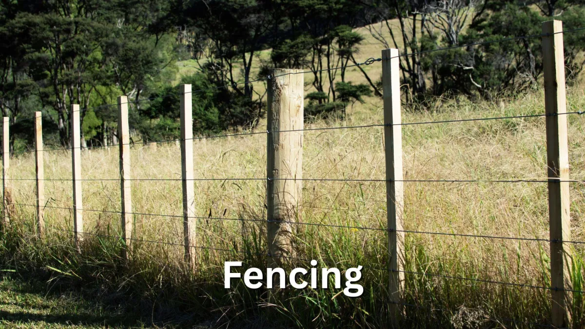 a farm wire and batten fence showing wires, a post and wooden battens.