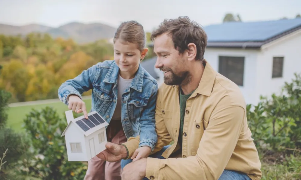 father and daughter with solar home