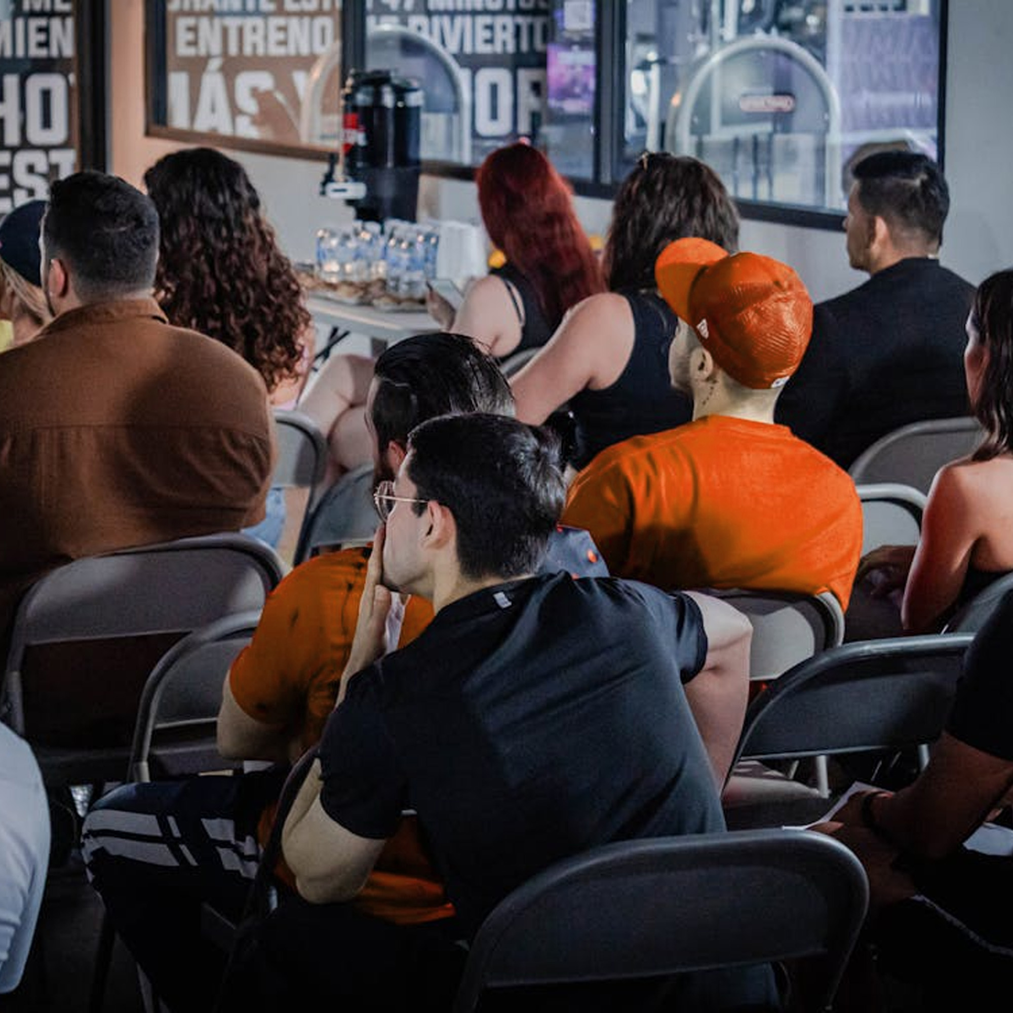 Photography of business event showcasing a room full of people viewing forward.