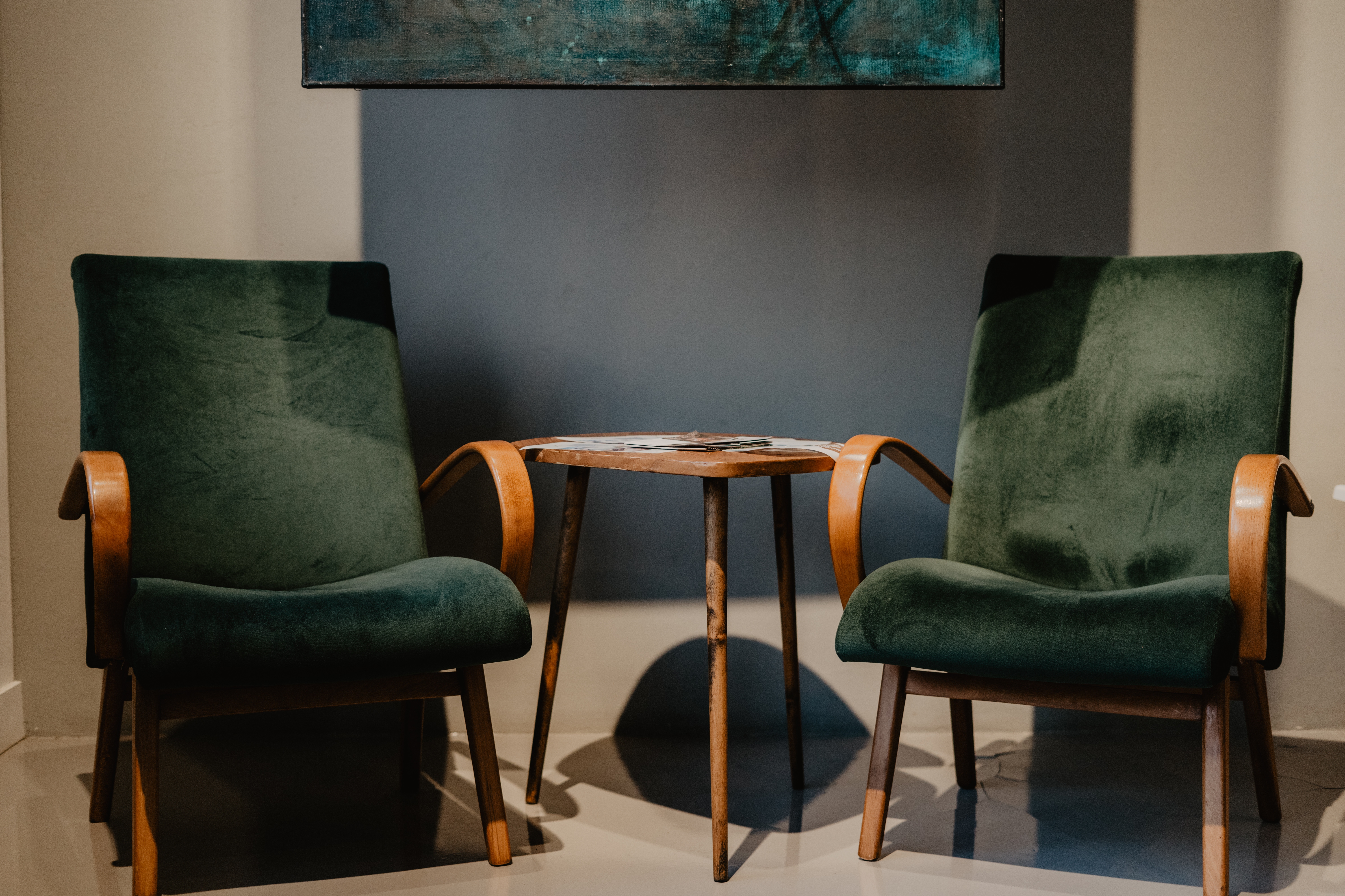 Two chairs facing each other in a warm, inviting setting, representing a supportive consultation conversation