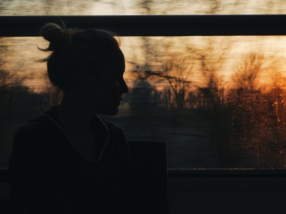 A person sitting quietly in warm window light, ten minutes that actually go somewhere