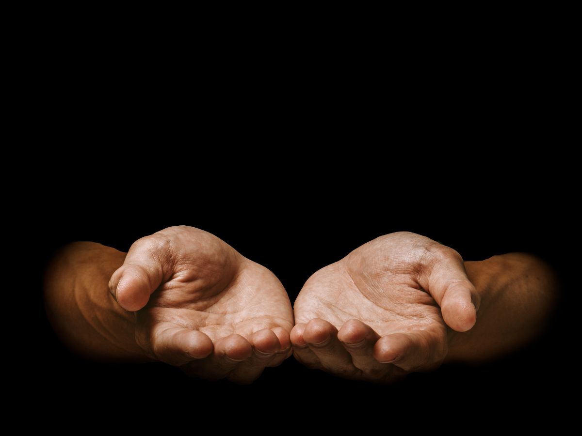 Open hands in warm light, the straight and honest deal behind