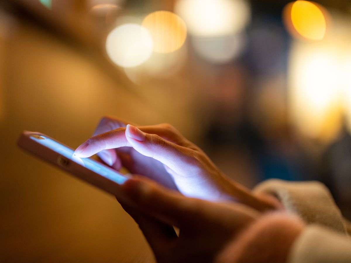 A hand holding a phone in warm evening light, North Star arriving with immediate access