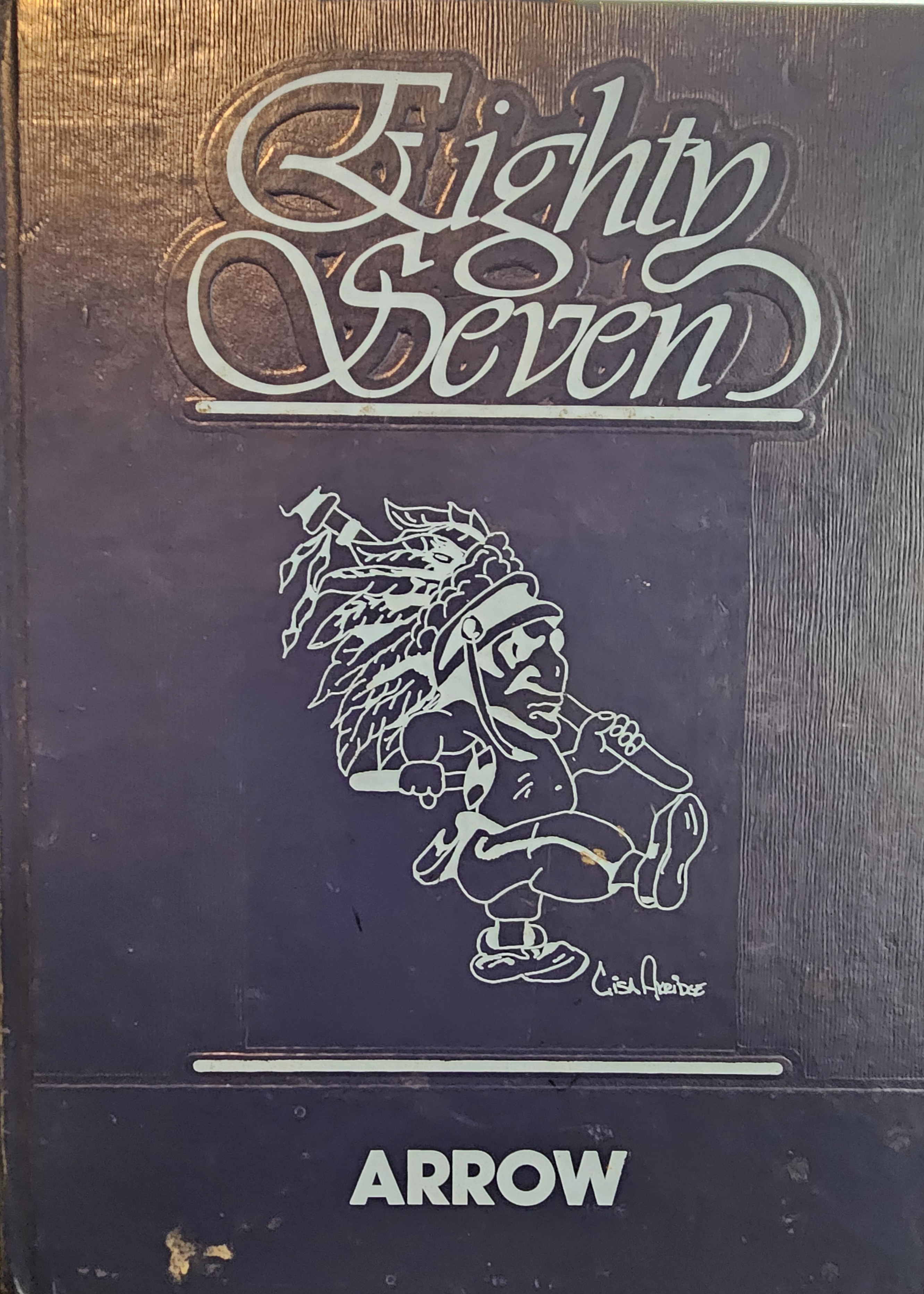 Iroquois High School alumni looking through nostalgic 1980s yearbooks and laughing together
