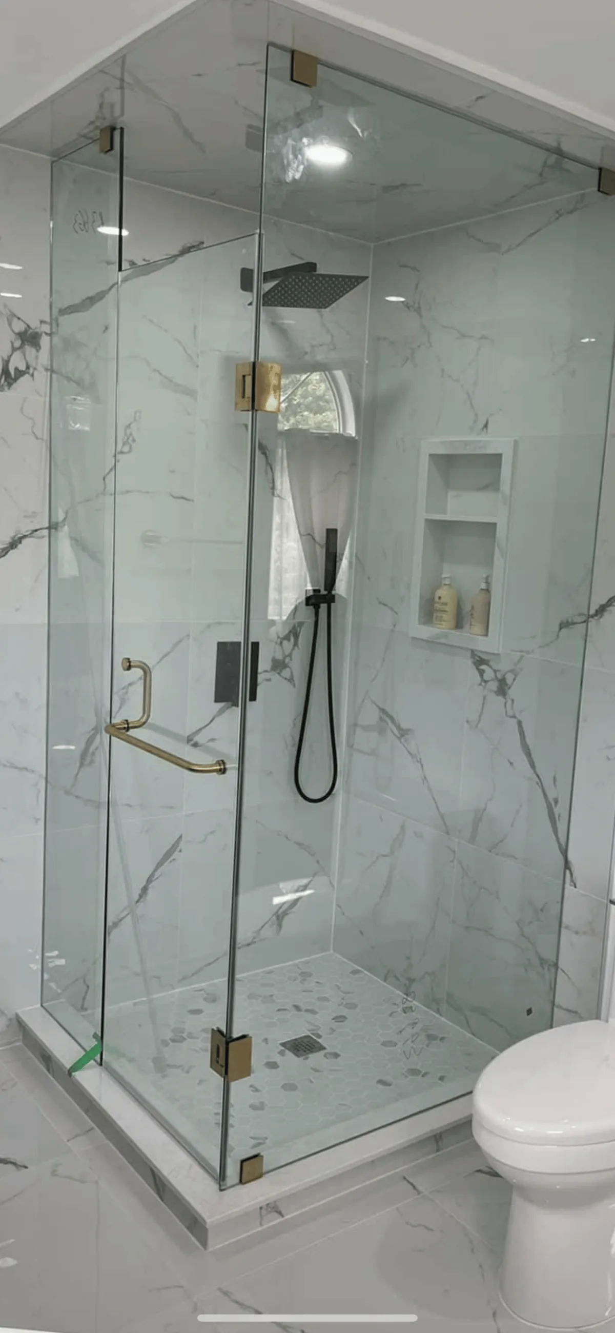  “Walk-in shower with low barrier entry and modern tile.”