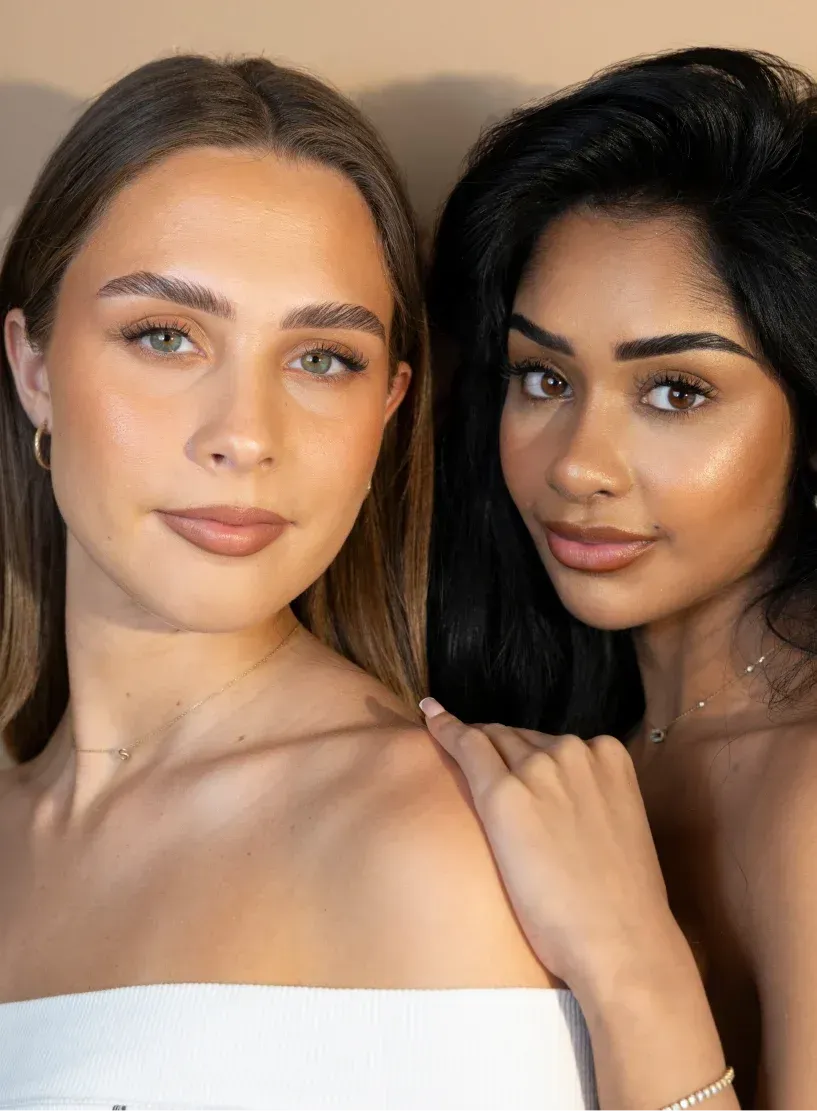 Two clients showcasing professionally shaped eyebrows