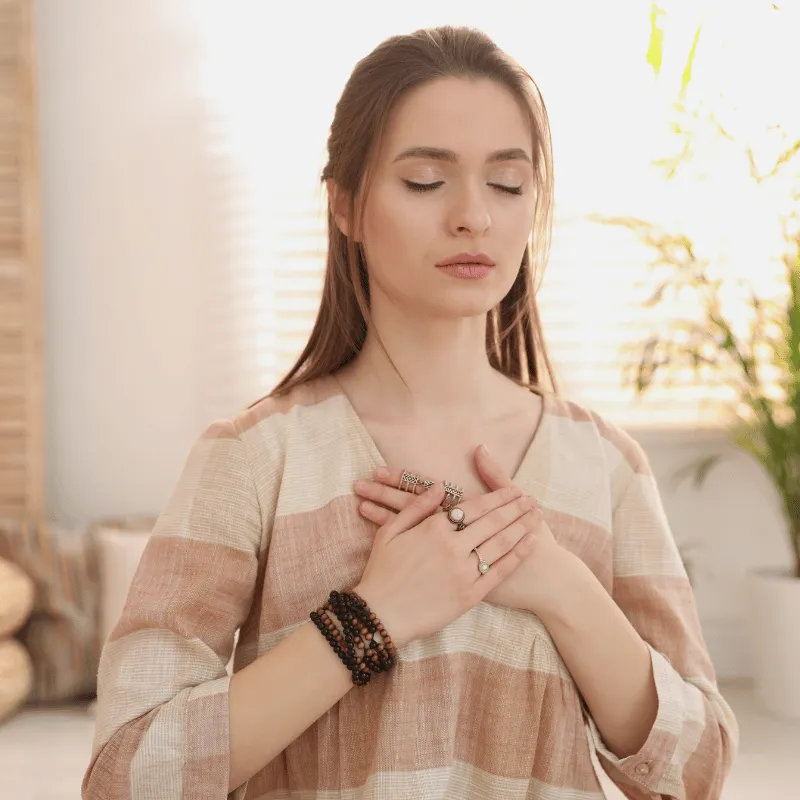 Woman holding hand across her chest