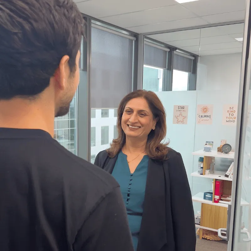 A therapist greeting a patient