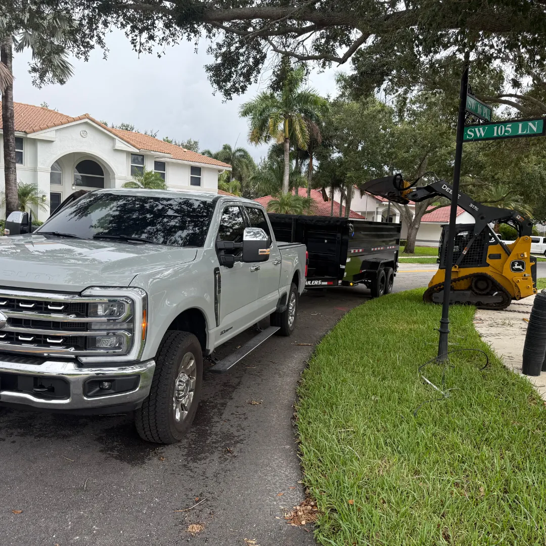 Trash & Go junk removal truck in Pompano Beach neighborhood hauling yard debris and furniture
