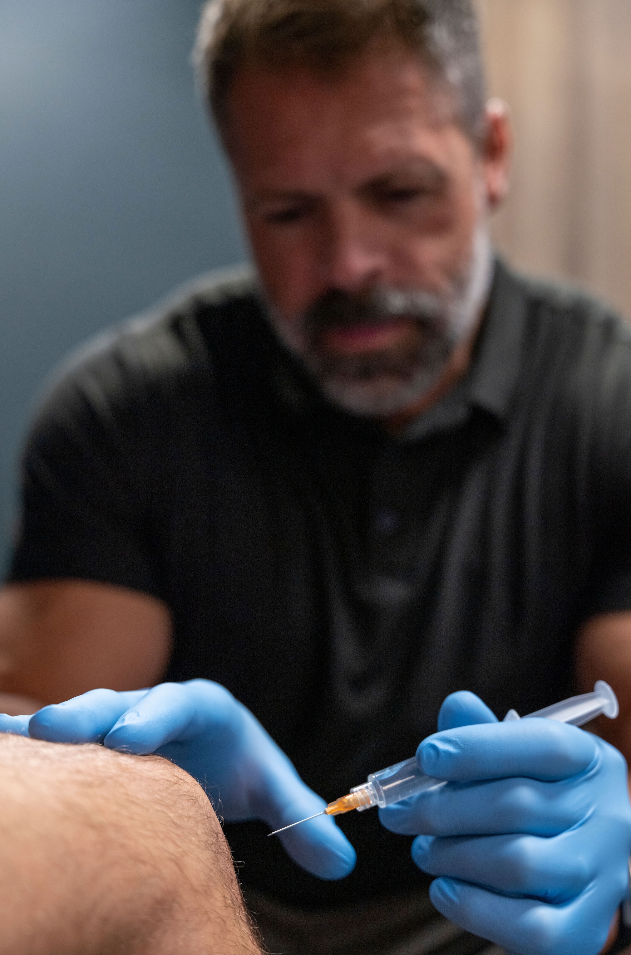 Private luxury medical suite with panoramic city view, plush seating, and gold accents