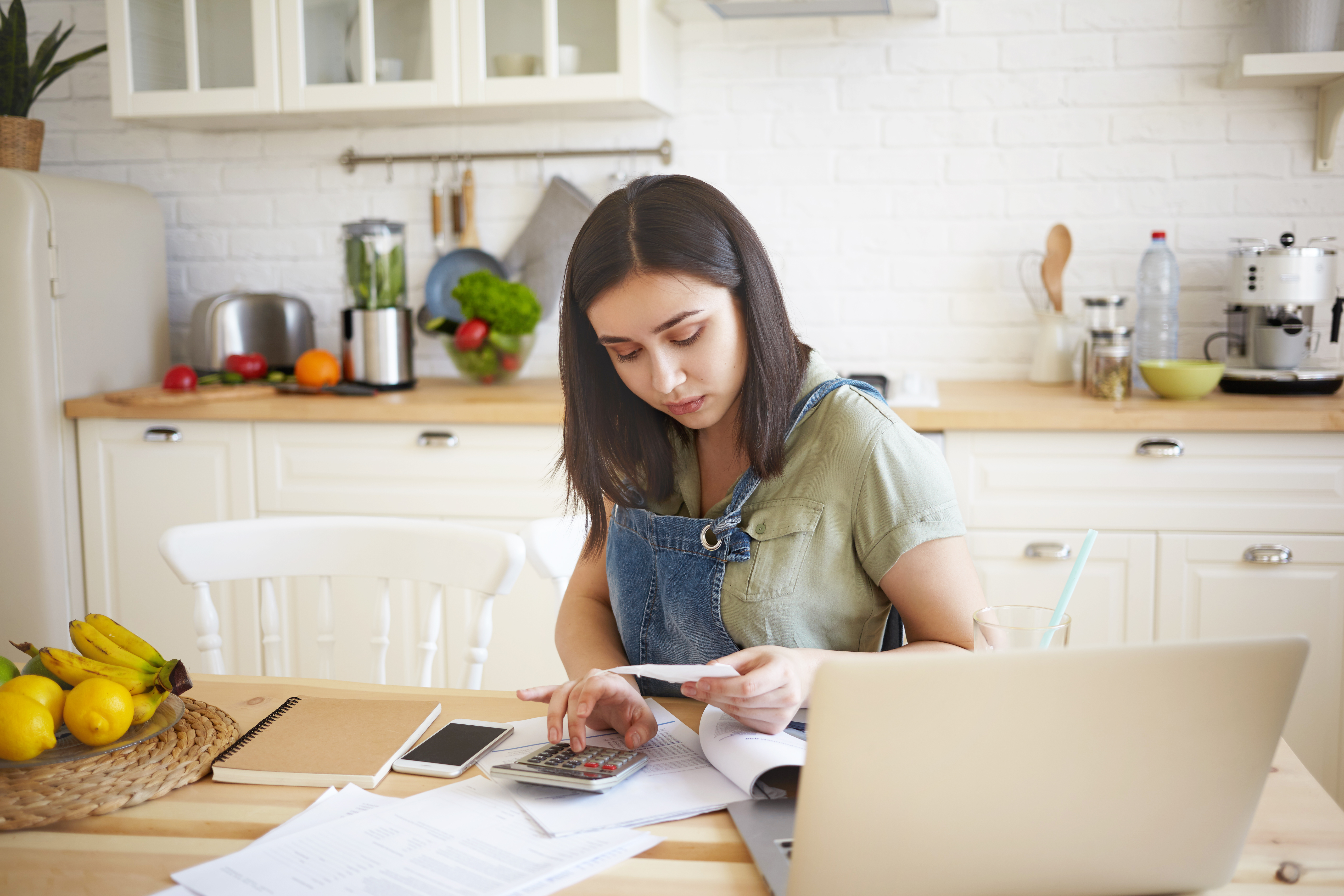 Person reviewing documents at kitchen table representing signature loans