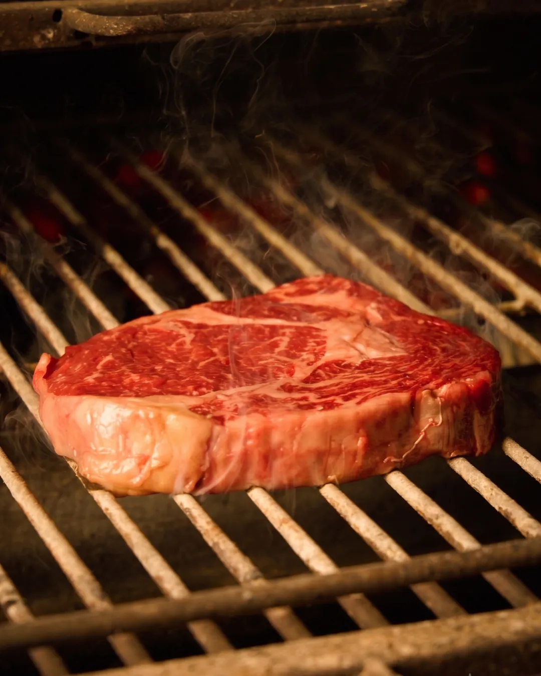 Steak searing over charcoal in a Josper oven highlighting the science of cooking at Bangkok Bob's