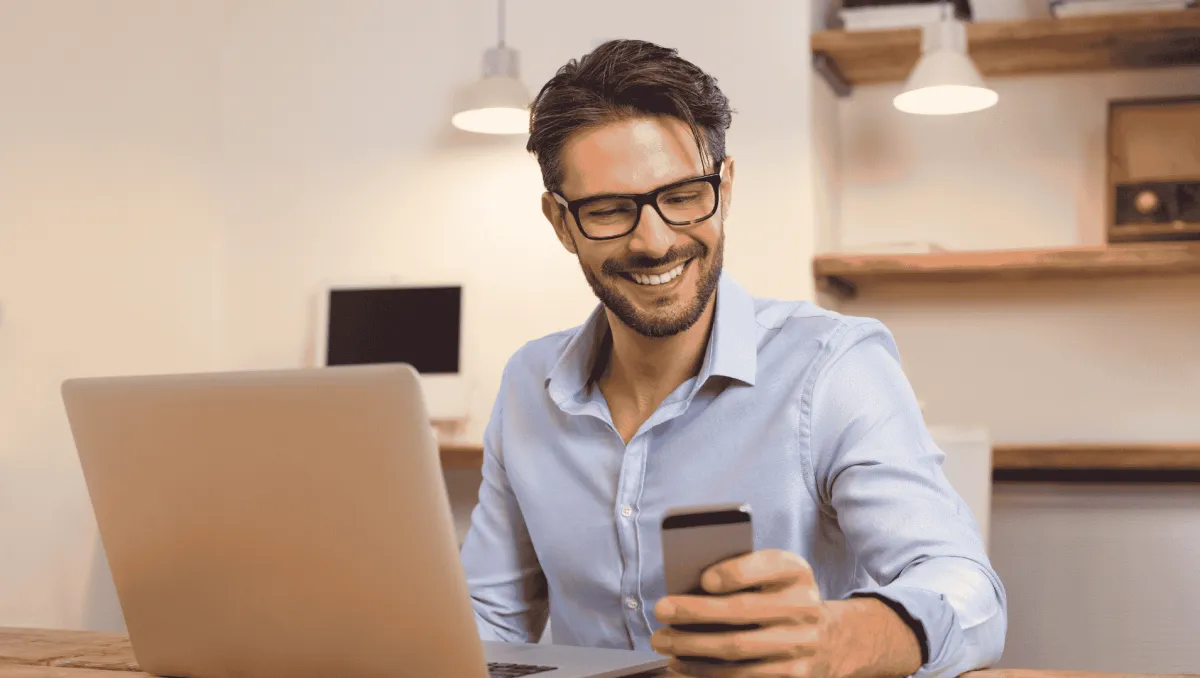 an Overseas Investor smiles as he gets updates on his mobile phone about his philippine property