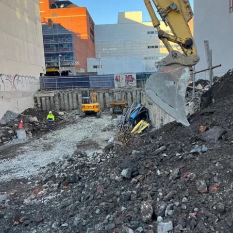 a picture of a digger bucket and some stones
