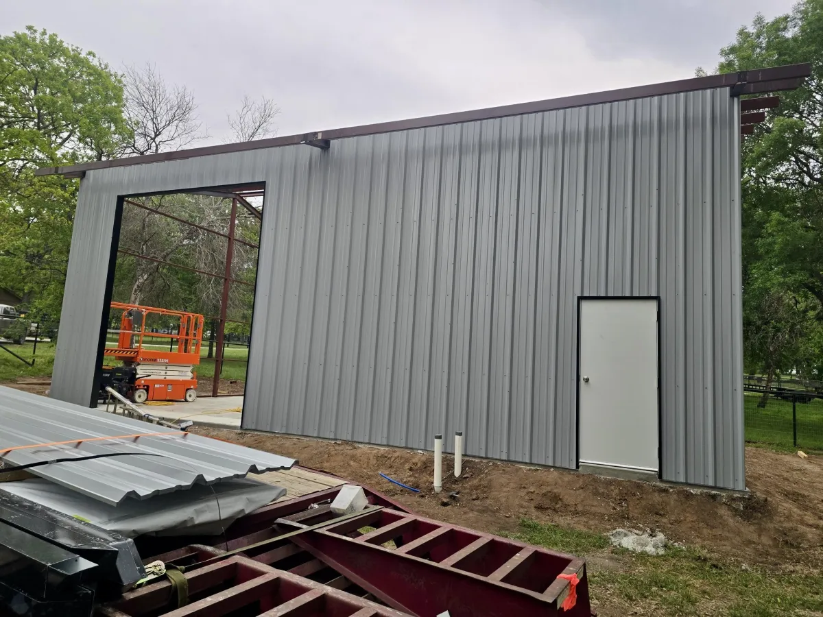 Metal building construction and addition