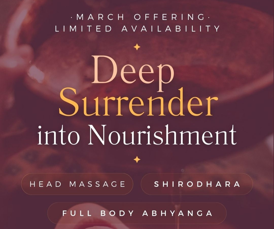 a person and a dog sitting on a hill overlooking a city